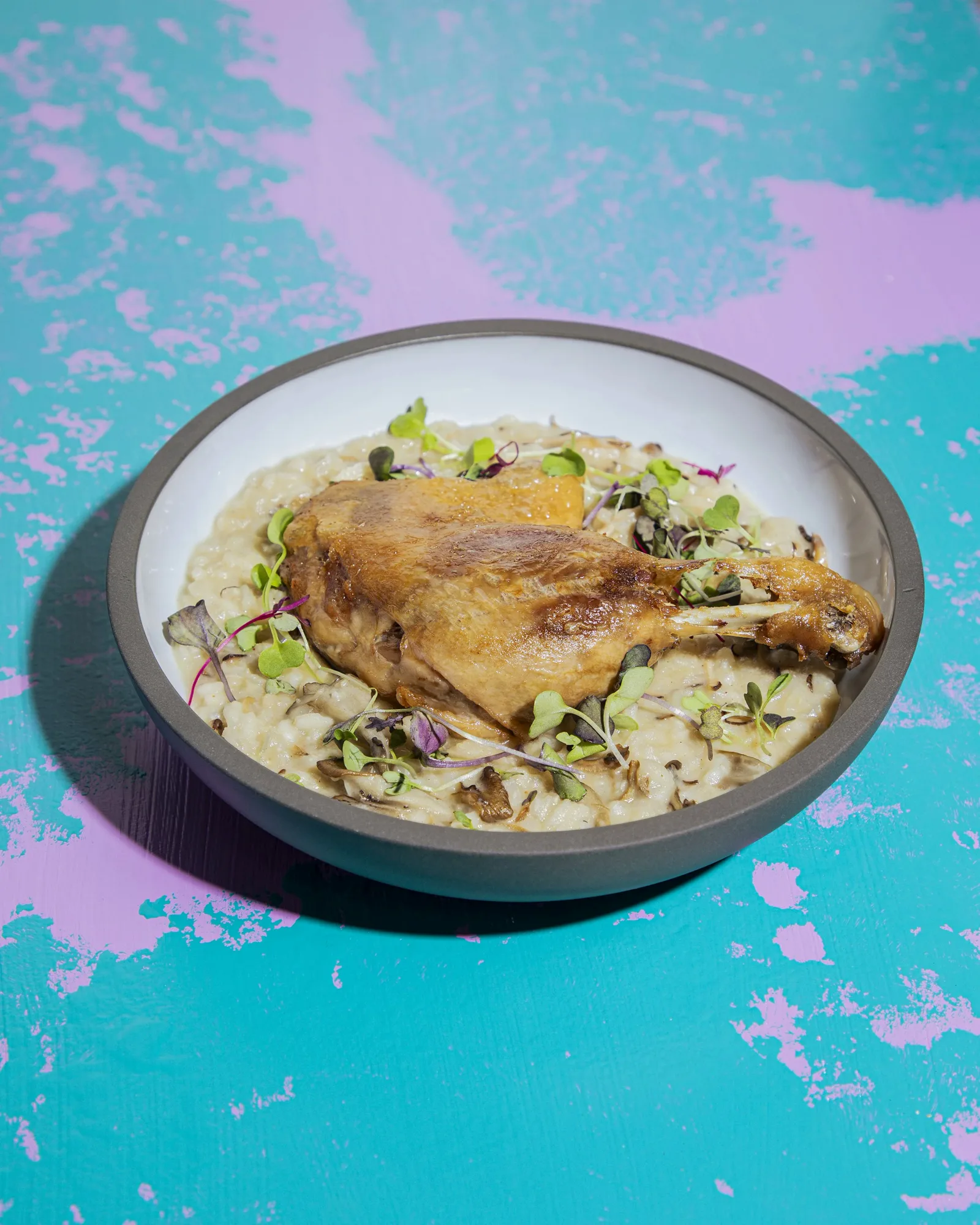 Duck confit over truffle mushroom risotto